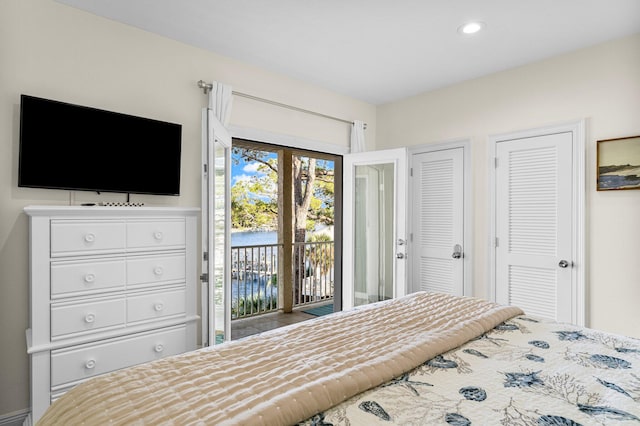 bedroom featuring access to exterior and multiple closets