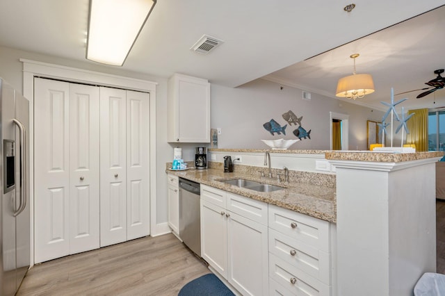 kitchen featuring white cabinets, kitchen peninsula, appliances with stainless steel finishes, and light hardwood / wood-style flooring