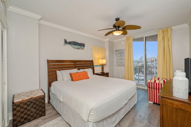 bedroom with access to exterior, ceiling fan, crown molding, and hardwood / wood-style flooring