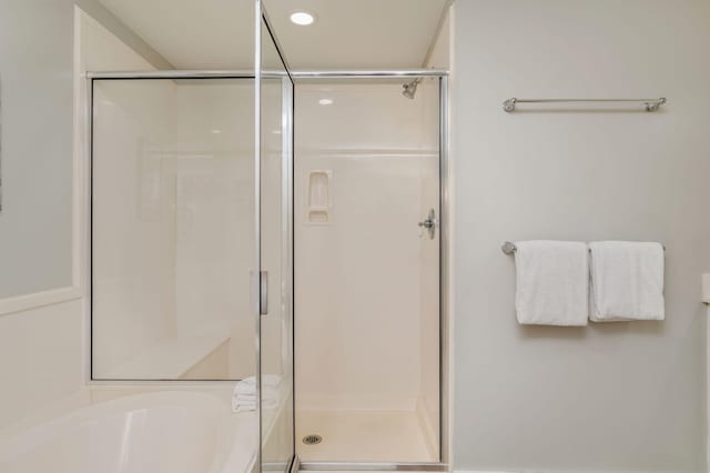 bathroom with separate shower and tub