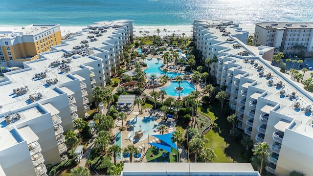 birds eye view of property with a water view and a beach view