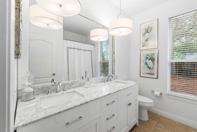 bathroom with tile patterned floors, curtained shower, vanity, and toilet