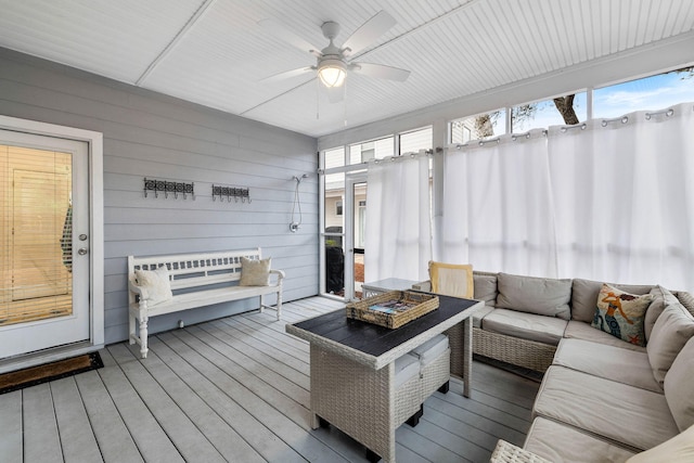 sunroom featuring ceiling fan