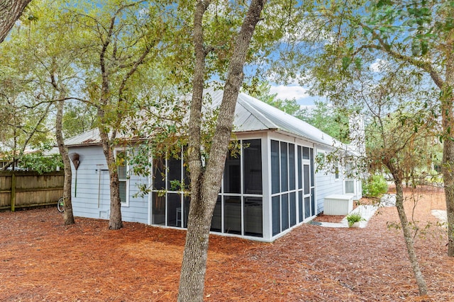 back of property with a sunroom