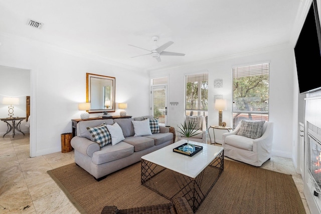 living room with ceiling fan and ornamental molding