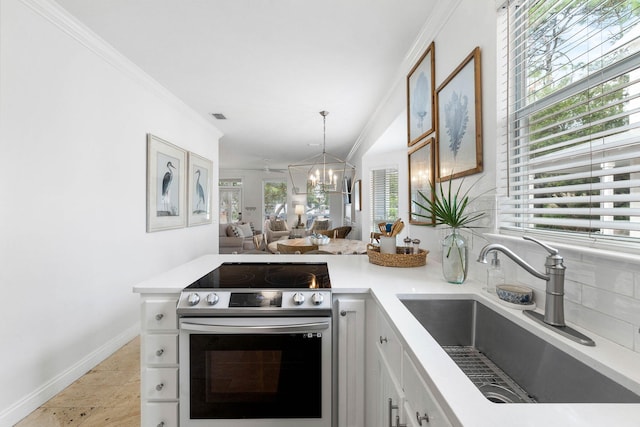 kitchen featuring an inviting chandelier, white cabinets, sink, electric range, and ornamental molding