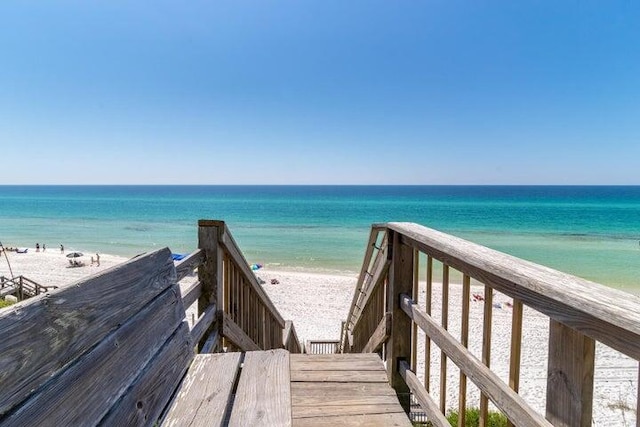 surrounding community featuring a view of the beach and a water view