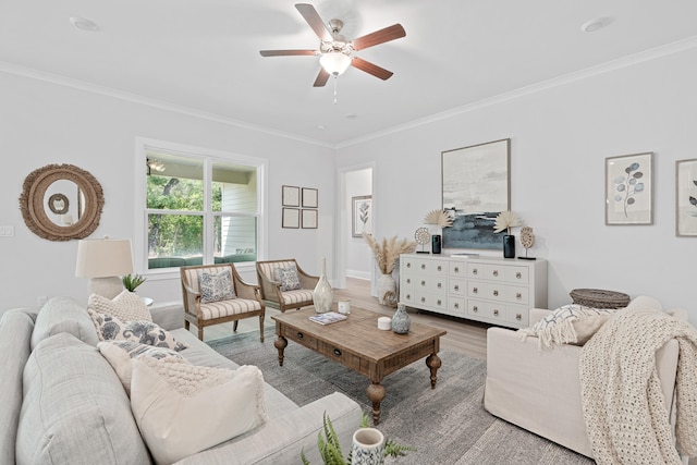 living room with ornamental molding, ceiling fan, and light hardwood / wood-style flooring