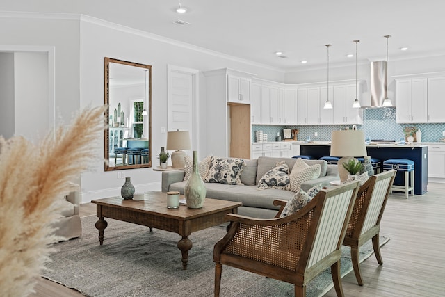 living room featuring light wood-type flooring and crown molding