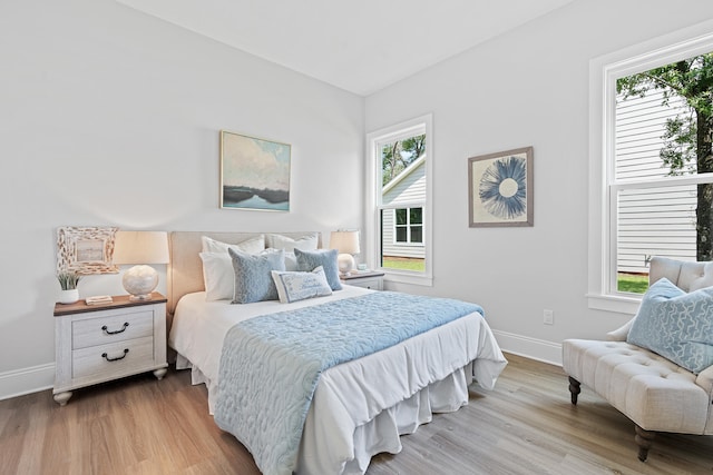 bedroom featuring hardwood / wood-style floors and multiple windows