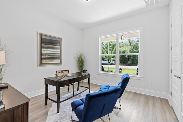 office space with light wood-type flooring