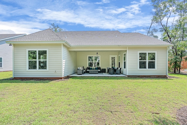 rear view of property featuring a yard, a patio area, and an outdoor living space