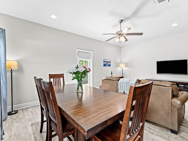 dining room with light wood-type flooring and ceiling fan