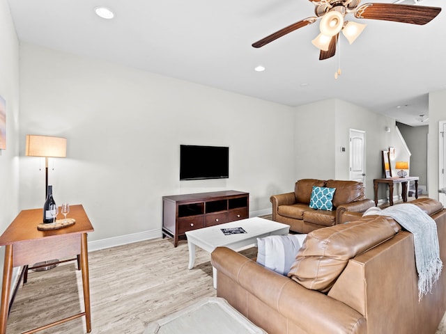 living room with ceiling fan and light hardwood / wood-style floors