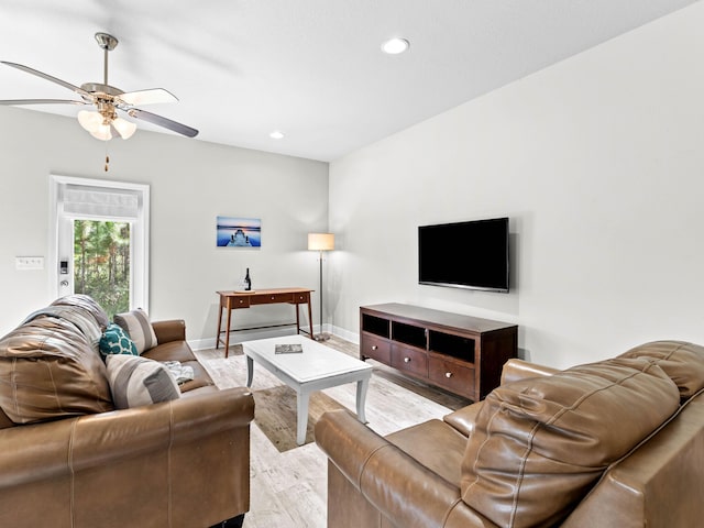 living room with ceiling fan and light wood-type flooring