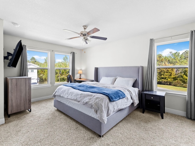 bedroom featuring ceiling fan and light carpet