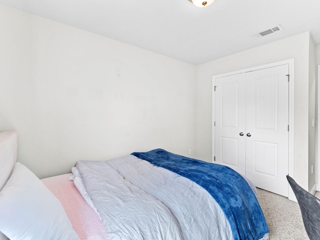 carpeted bedroom with a closet