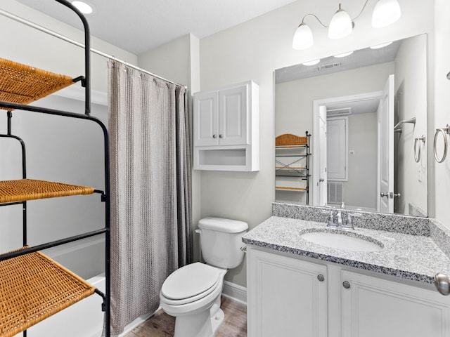 full bathroom with hardwood / wood-style floors, vanity, shower / bath combination with curtain, and toilet