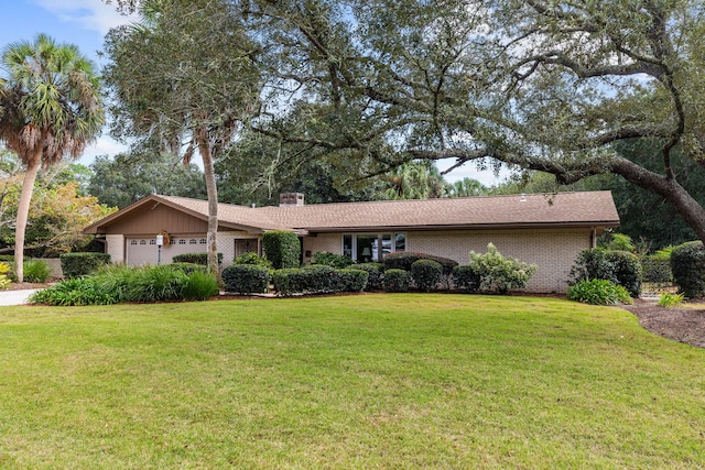 ranch-style house featuring a garage and a front yard