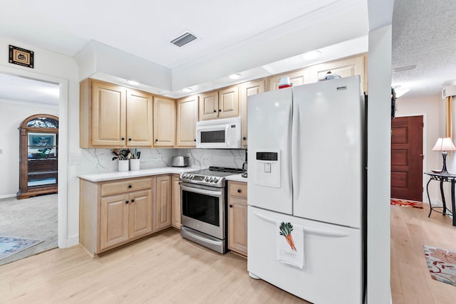 kitchen featuring decorative backsplash, light brown cabinets, white appliances, and light hardwood / wood-style floors