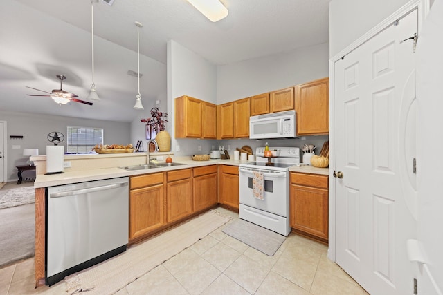 kitchen featuring decorative light fixtures, white appliances, sink, kitchen peninsula, and ceiling fan