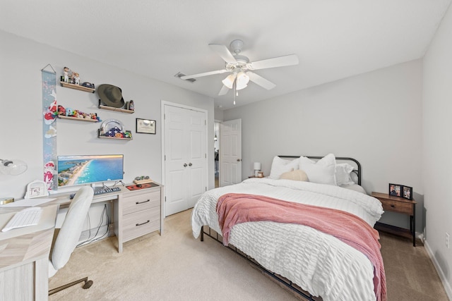 bedroom with ceiling fan and light carpet