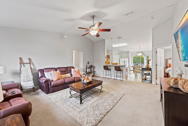 living room featuring vaulted ceiling, light carpet, and ceiling fan