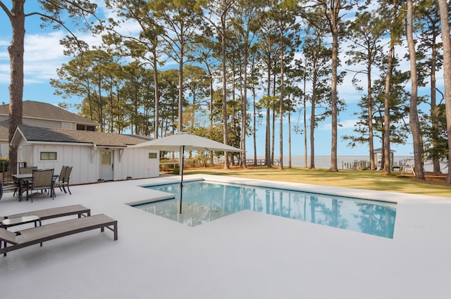 view of swimming pool with a yard and a patio