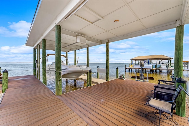 dock area with a water view and boat lift