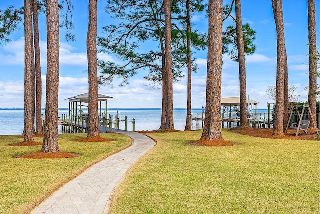 exterior space with a water view, boat lift, and a boat dock