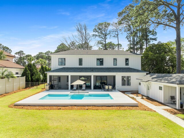 back of property with a patio area, a fenced backyard, a fenced in pool, and a yard