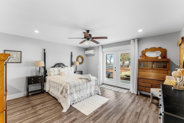 bedroom featuring a wall unit AC, recessed lighting, wood finished floors, access to outside, and french doors