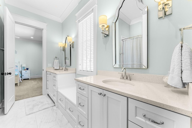 full bathroom with marble finish floor, ornamental molding, two vanities, and a sink