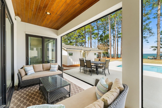 sunroom / solarium featuring plenty of natural light and wood ceiling