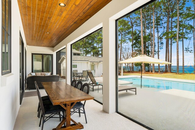 sunroom / solarium featuring wooden ceiling