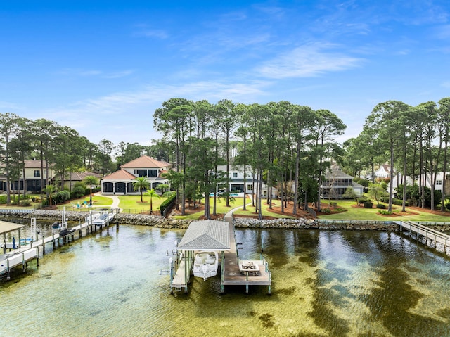 dock area with a water view, a yard, and boat lift