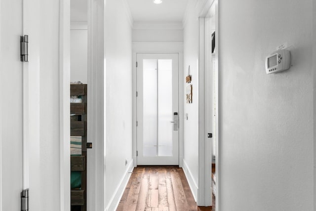 hallway featuring hardwood / wood-style floors and ornamental molding