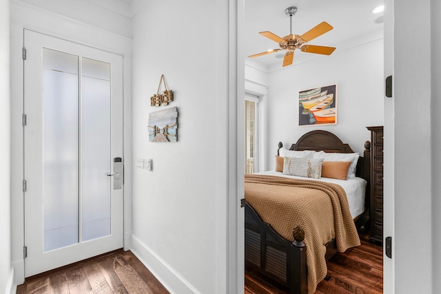 bedroom featuring ornamental molding, ceiling fan, and dark wood-type flooring