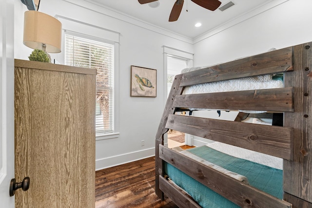 bedroom with ornamental molding, ceiling fan, multiple windows, and dark hardwood / wood-style flooring