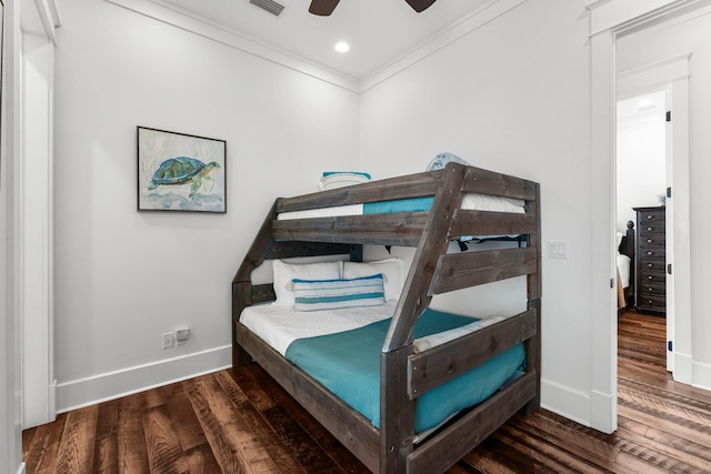 bedroom featuring ceiling fan, dark hardwood / wood-style flooring, and crown molding