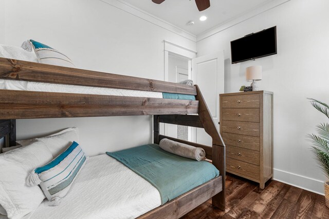 bedroom with ceiling fan, dark hardwood / wood-style flooring, and ornamental molding