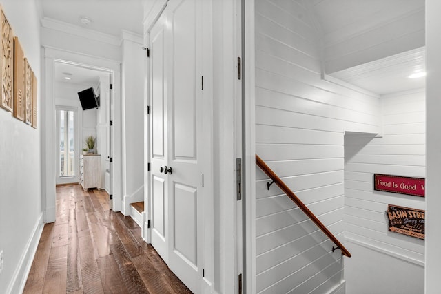 corridor featuring dark hardwood / wood-style flooring and crown molding