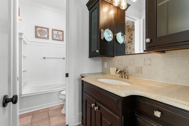 full bathroom with vanity, toilet, crown molding, tile patterned flooring, and backsplash