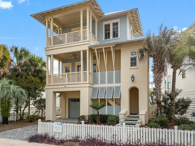 view of front of house with a balcony, a garage, and ceiling fan