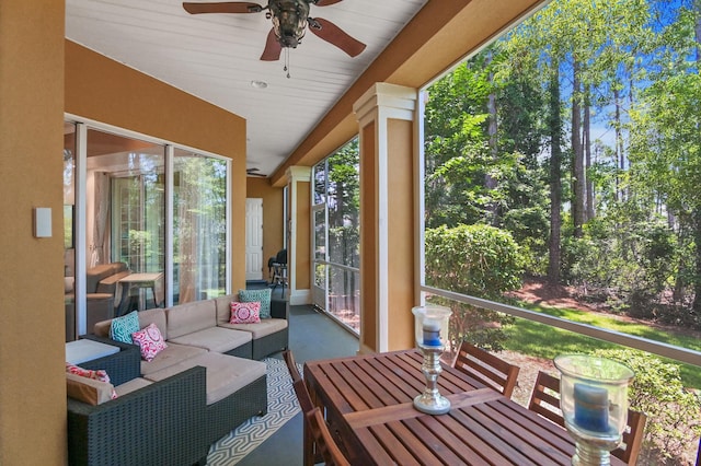 sunroom featuring a wealth of natural light and ceiling fan