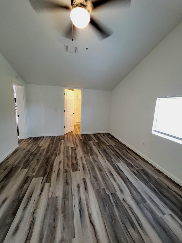 bonus room with lofted ceiling with skylight, ceiling fan, and dark hardwood / wood-style flooring