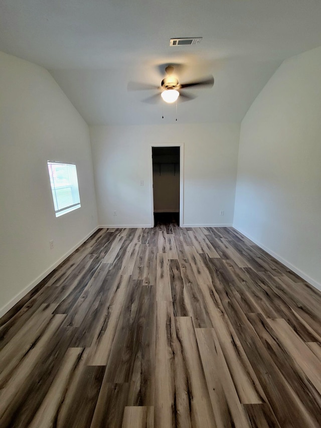 unfurnished room with ceiling fan, wood-type flooring, and lofted ceiling