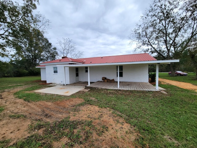 back of property featuring a yard and a patio