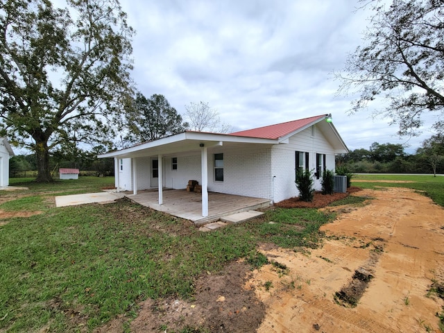 view of home's exterior featuring central AC unit and a lawn