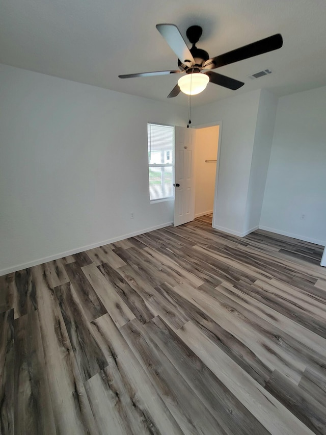 unfurnished room with hardwood / wood-style floors and ceiling fan